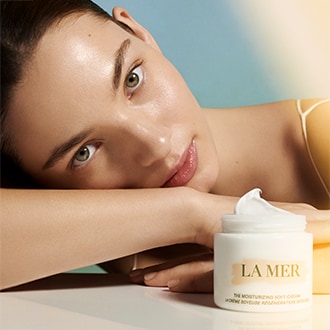 Close up of model applying The Eye Concentrate to under eyes using applicator