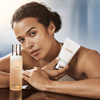 Close up of model cleansing skin, focusing on product texture on skin